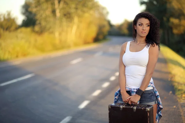 Beauty girl with old suitcase on the road — Stock Photo, Image