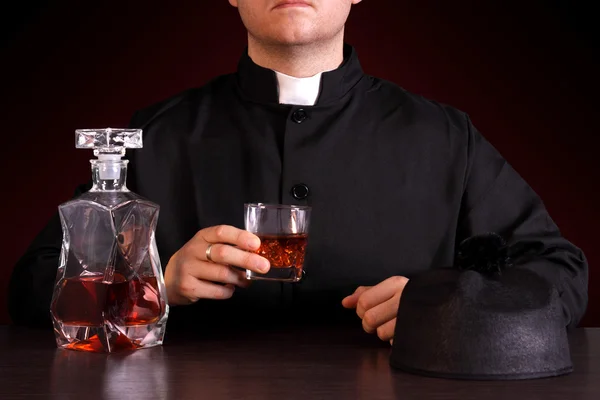 Priest drinking alcohol — Stock Photo, Image