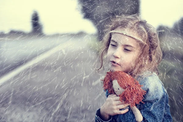 Waise an einem verschneiten Wintertag allein im Freien sitzend — Stockfoto