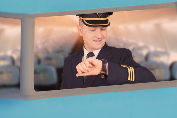 Pilot looks at his watch in the cockpit
