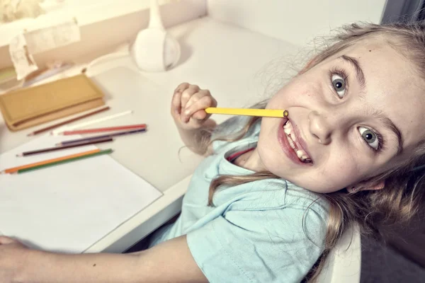 Happy young girl doing homework — Stock Photo, Image