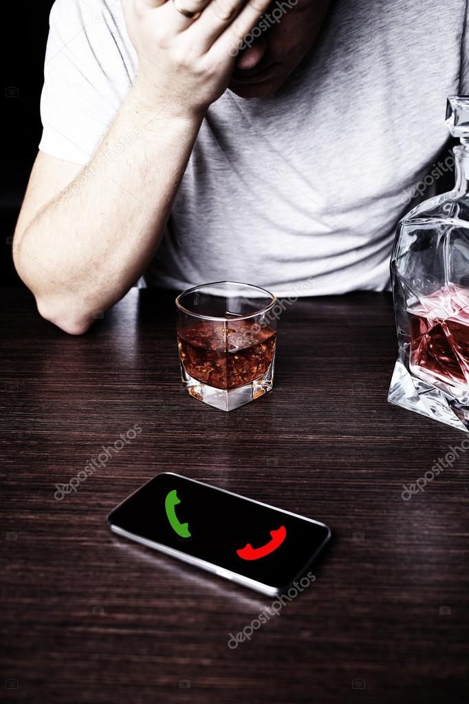 Drunk man in front of a mobile phone