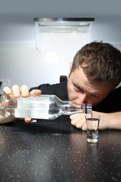 Betrunkener schenkt ein Glas Wodka ein — Stockfoto