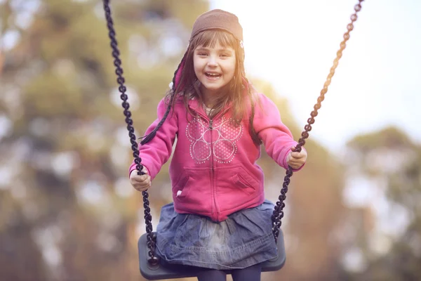 Adolescent girl swinging on a swing — Stock Photo, Image