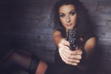 A pretty girl holding a gun clipart