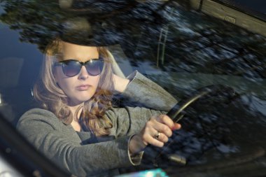 young woman driving a car clipart