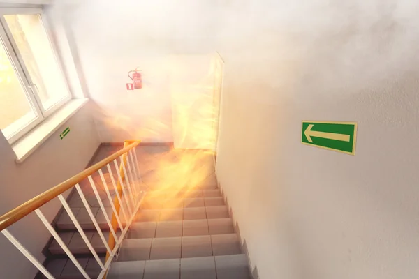 Emergency exit and fire in the building — Stock Photo, Image