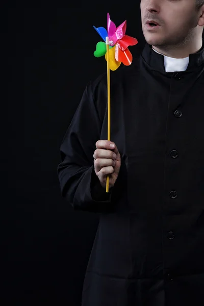 Priest with a colored heat sink — Stock Photo, Image