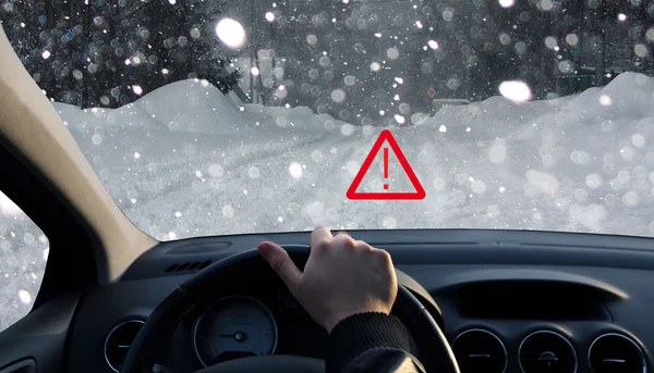 The technology displays a warning about the bad conditions of the road in the car — Stock Photo, Image