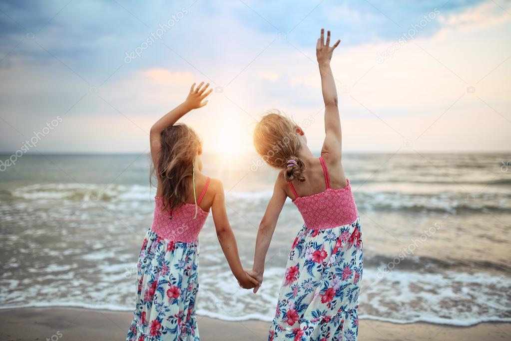 Two young girls have fun at the beach