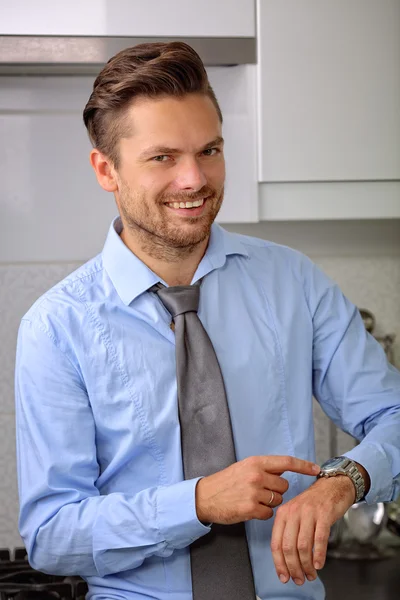 Schöner Mann macht sich bereit für die Arbeit und zeigt, dass er wenig Zeit hat — Stockfoto