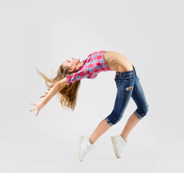 Young dancing girl in jeans — Stock Photo, Image