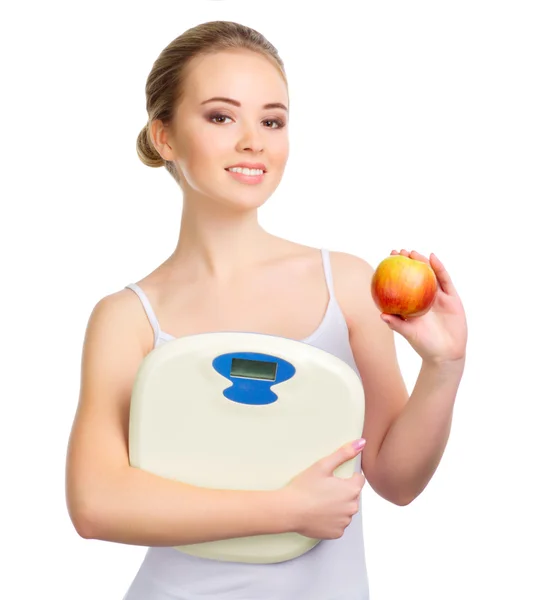 Young healthy girl with apple and scales — Stock Photo, Image