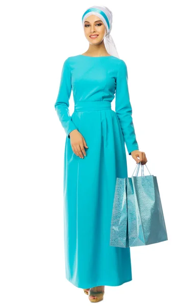 Muslim woman in blue dress with bags — Stock Photo, Image