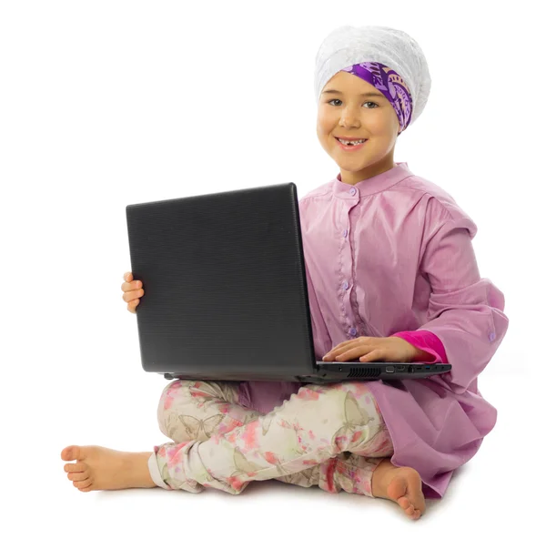 Little muslim girl with laptop — Stock Photo, Image