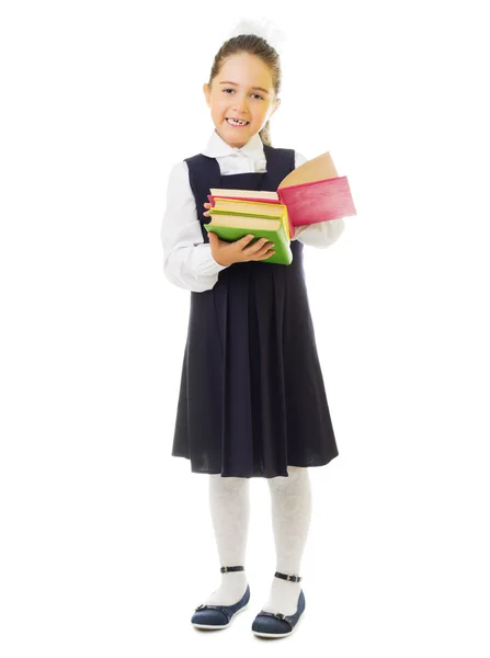 Piccola studentessa sorridente con libri — Foto Stock