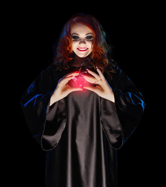 Young witch with red potion isolated — Stock Photo, Image