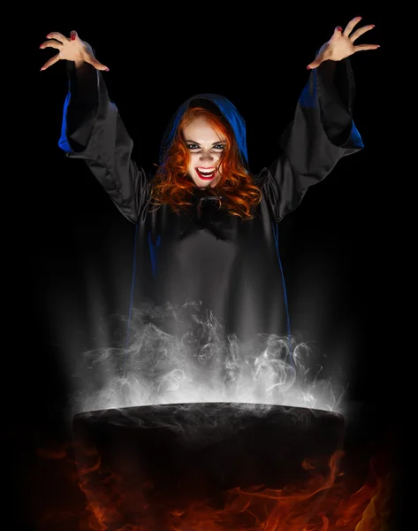 Young witch with cauldron isolated — Stock Photo, Image