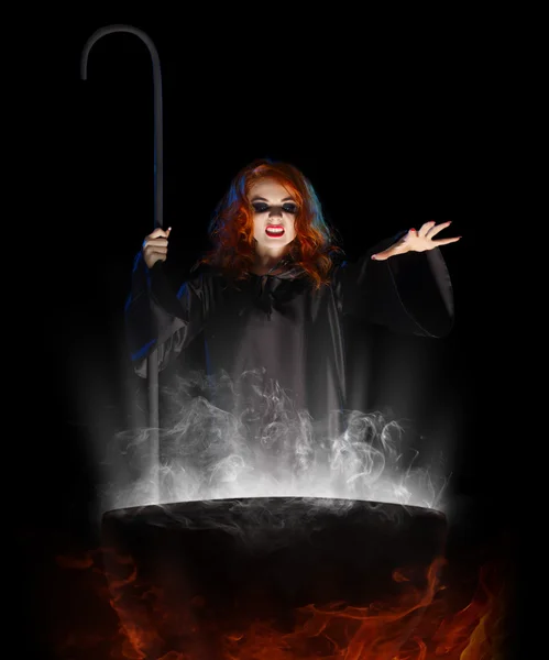 Young witch with cauldron — Stock Photo, Image