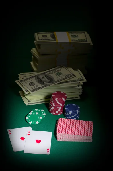 Stack of dollars chips and playing cards — Stock Photo, Image