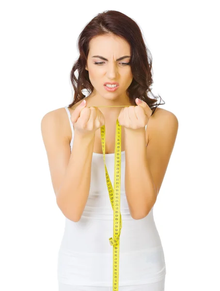 Young displeased girl with measurement tape — Stock Photo, Image