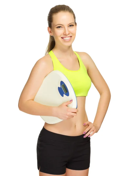 Young sporty girl with scales — Stock Photo, Image