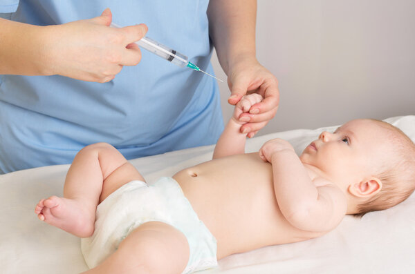 Doctor doing inoculation to baby