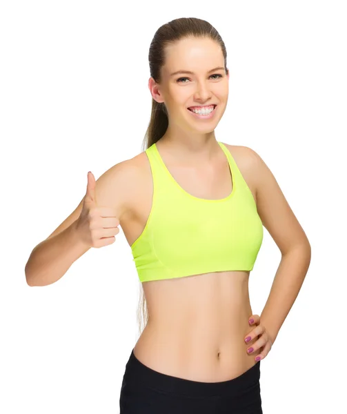 Sporty girl shows ok gesture — Stock Photo, Image