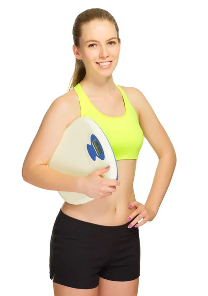 Young sporty girl with home scales — Stock Photo, Image