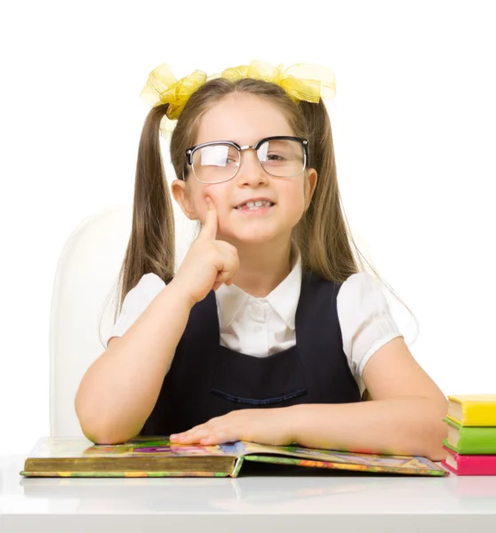 Little schoolgirl at the table — Stock Photo, Image