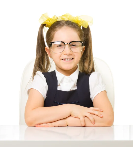 Little schoolgirl at the table — Stock Photo, Image