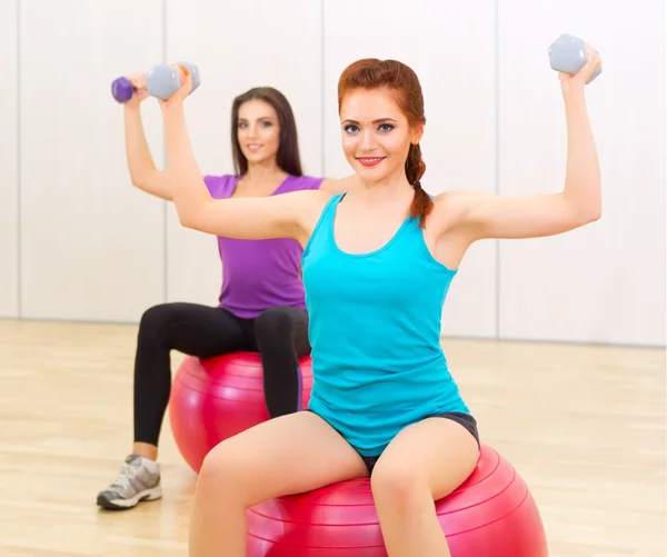 Two young girls doing gymnastic exercises — Stock Photo, Image