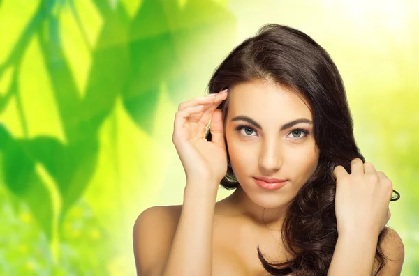 Young woman on floral background — Stock Photo, Image