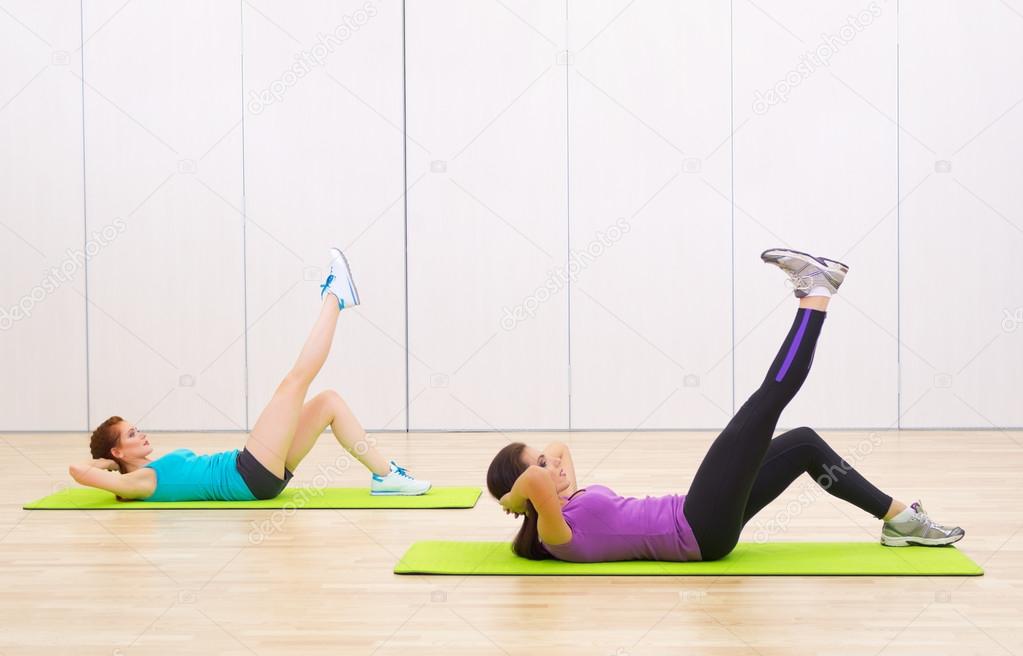 Two sporty girls at fitness club