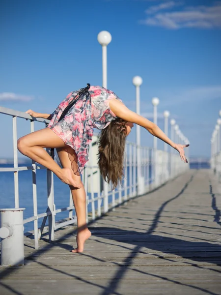 Chica joven haciendo ejercicios de gimnasia en el muelle (ver normal ) — Foto de Stock