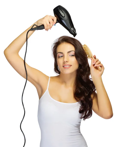 Young girl with hair dryer and brush — Stock Photo, Image