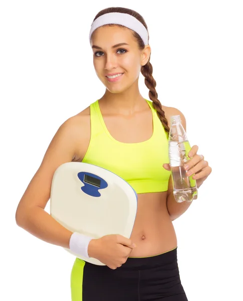 Sporty girl with scales and water — Stock Photo, Image