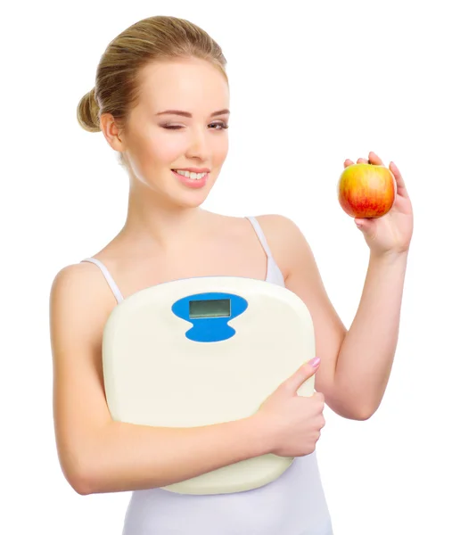 Young healthy girl white apple and scales — Stock Photo, Image