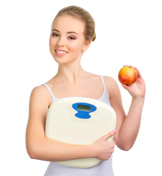 Young healthy girl with apple and scales — Stock Photo, Image
