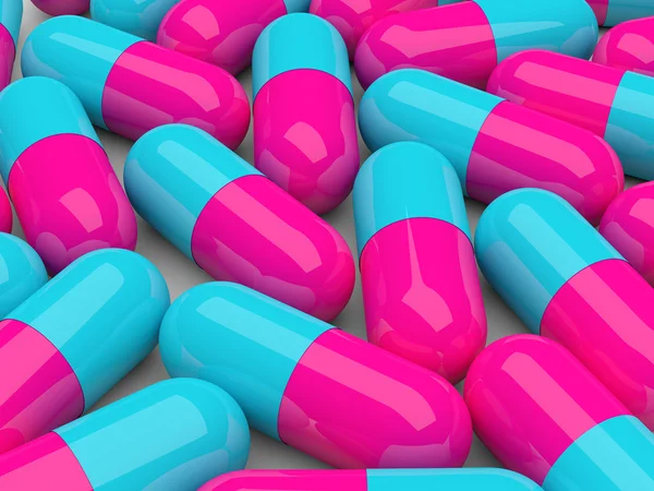 Pílulas com reflexo isolado sobre branco — Fotografia de Stock
