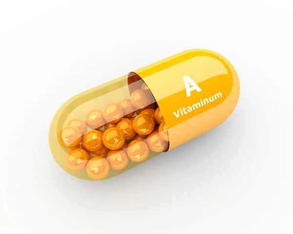 Капсула витамина А лежит на столе — стоковое фото