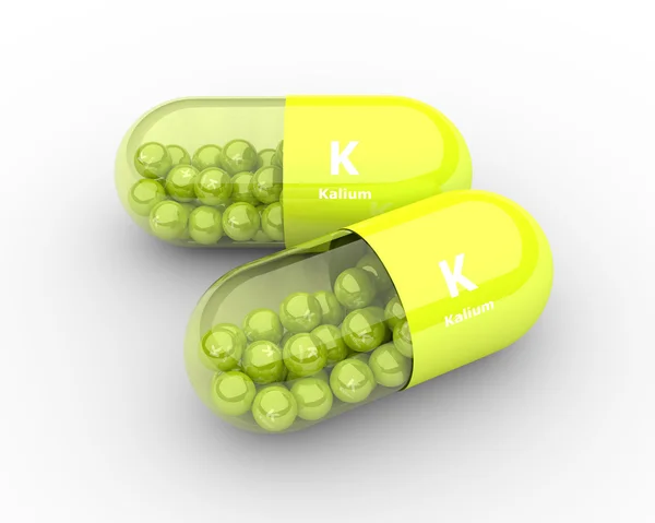 Kalium pill with granules lying on table — Stock Photo, Image