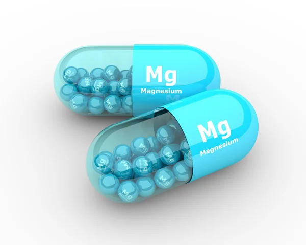 Magnesium capsule with granules lying on table — Stock Photo, Image