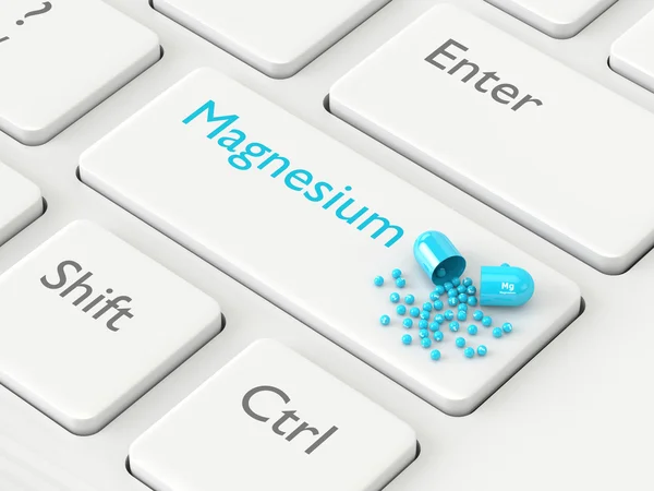 3d renderizado pílula de magnésio Mg deitado no teclado — Fotografia de Stock