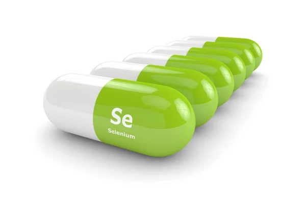 Selenium pills lying on white table — Stock Photo, Image