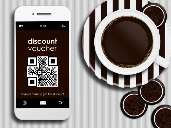 Mobilní telefon s slevový kupón, šálek kávy a perník — Stock fotografie