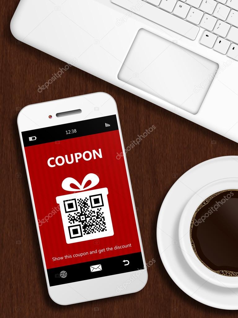 mobile phone with christmas coupon, laptop and cup of coffee