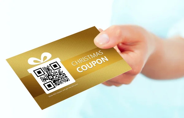 Gold christmas coupon holded by hand over white — Stock Photo, Image