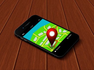 Masanın üzerinde yatan harita ve gps uygulaması ile cep telefonu