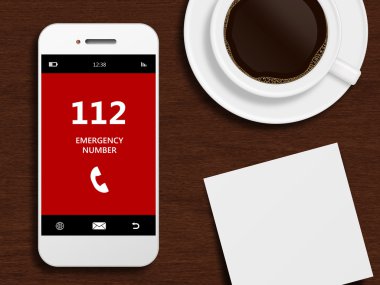 Acil durum numarası 112 masanın üstüne yalan ile cep telefonu
